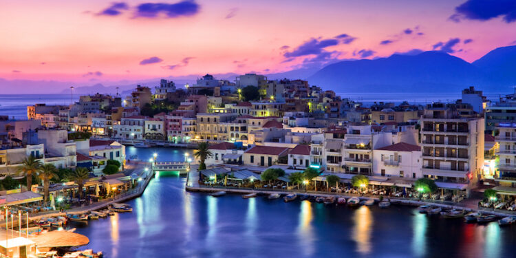 Agios Nikolaos. Agios Nikolaos is a picturesque town in the eastern part of the island Crete built on the northwest side of the peaceful bay of Mirabello.